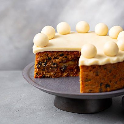 Easter simnel cake on a cake stand. Grey background. Copy space. Easter simnel cake on a cake stand. Grey background. Copy space.